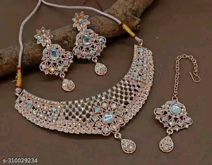 Jewelry set with necklace, earrings, and hair accessory on a brown background
